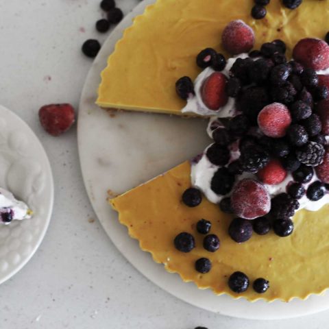 Lemon and Cashew Vegan Raw Cheesecake with slice taken out of it